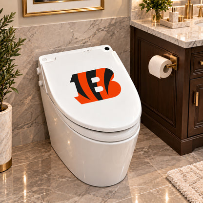Cincinnati Bengals decorative sticker on a closed white toilet lid in a marble bathroom