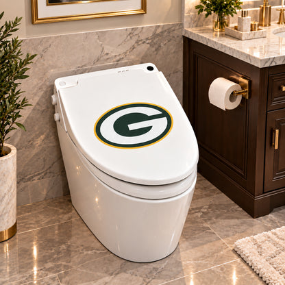 Green Bay Packers decorative sticker on a closed white toilet lid in a marble bathroom