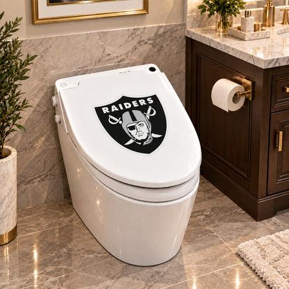 Las Vegas Raiders decorative sticker on a closed white toilet lid in a marble bathroom