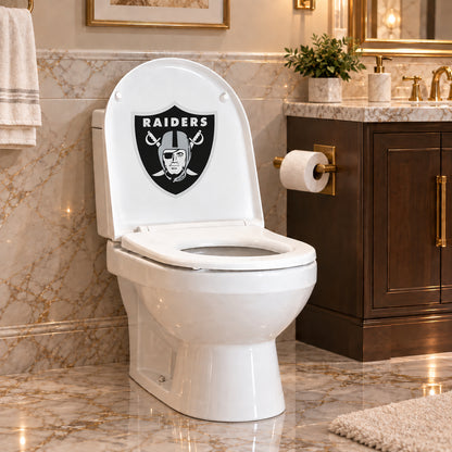 Las Vegas Raiders decorative sticker on the inside of a white toilet lid in a marble bathroom