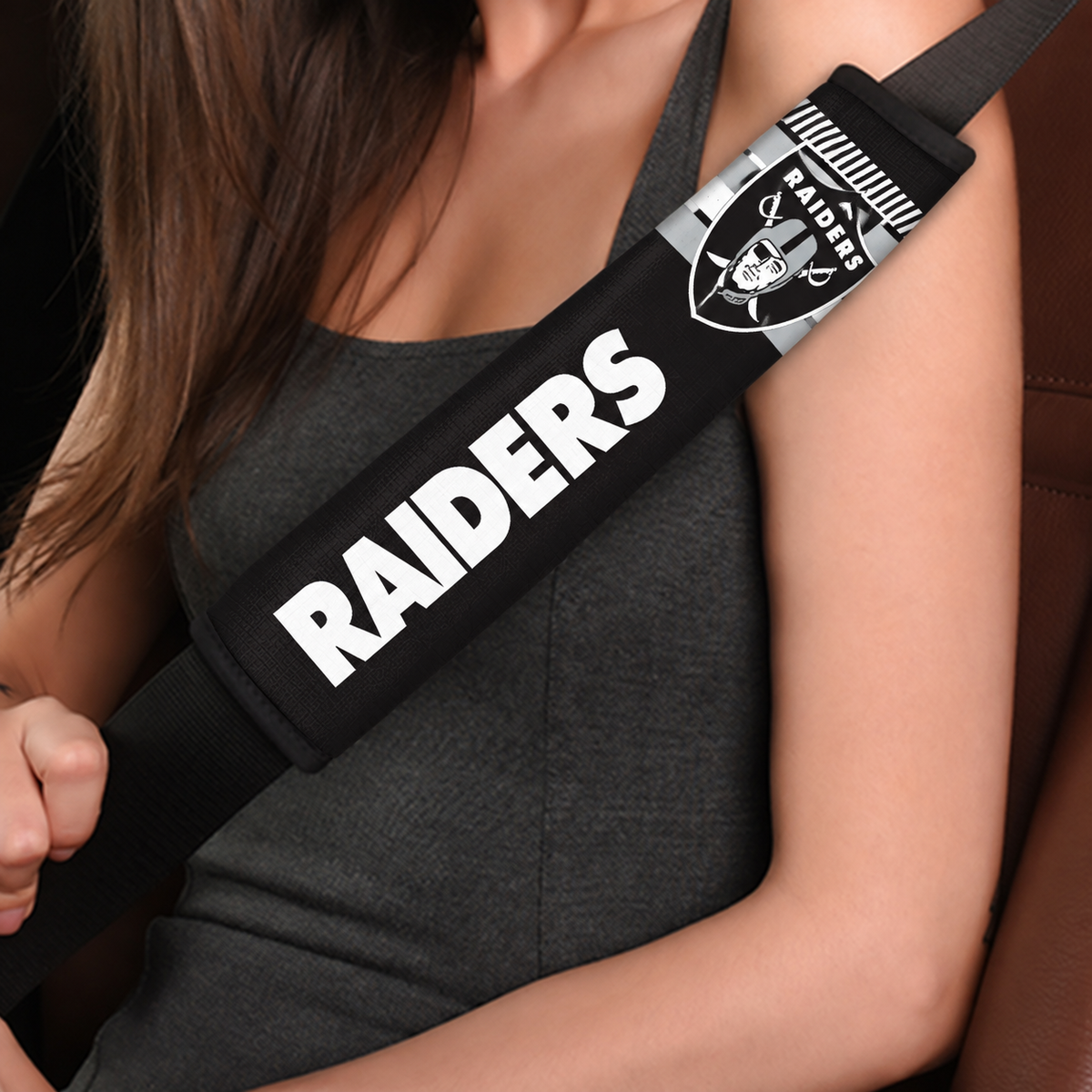 Close-up of Las Vegas Raiders shoulder strap cover worn on a car seat belt
