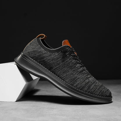 Men's breathable knit dress sneakers, black upper with black sole, side view