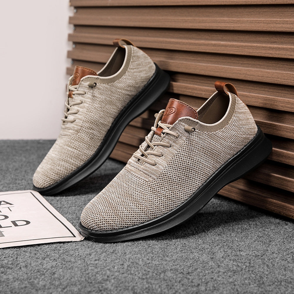 Men's breathable knit dress sneakers, cream upper with black sole, angled pair view