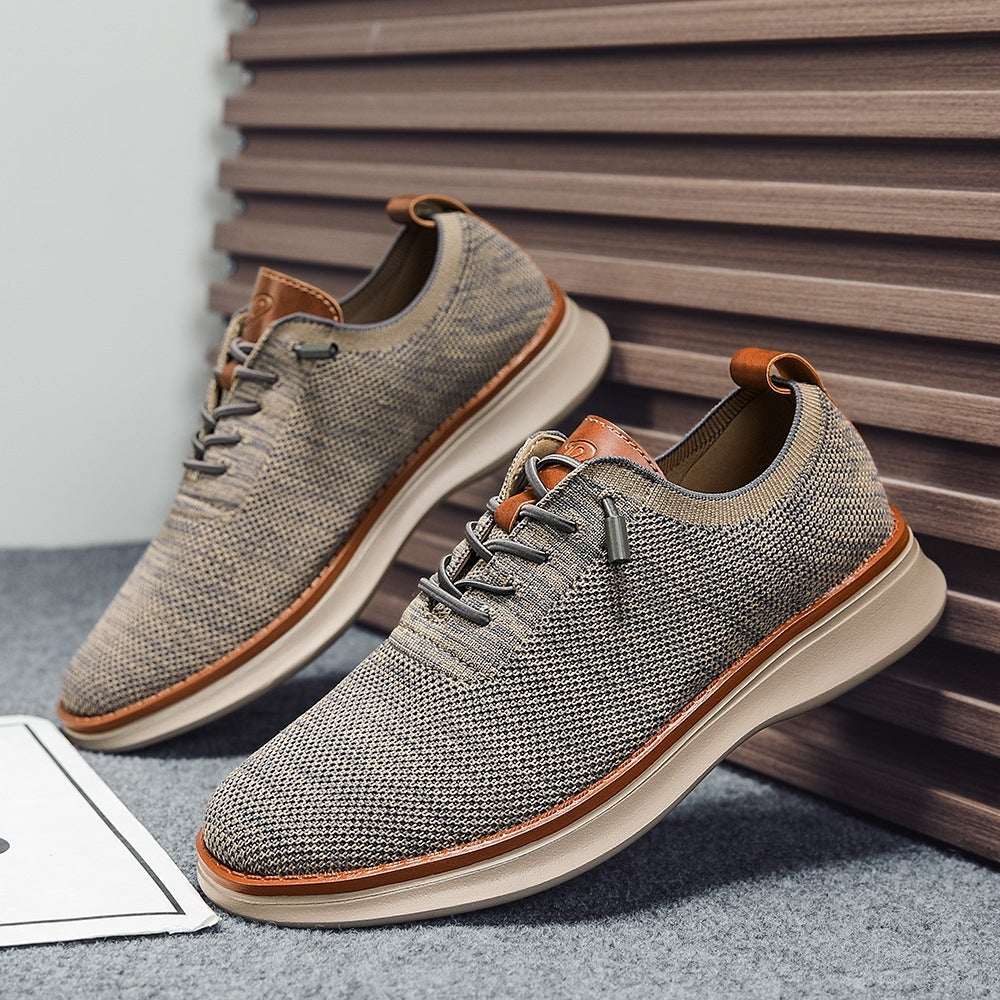 Men's breathable knit dress sneakers, gray upper with beige sole, angled pair view