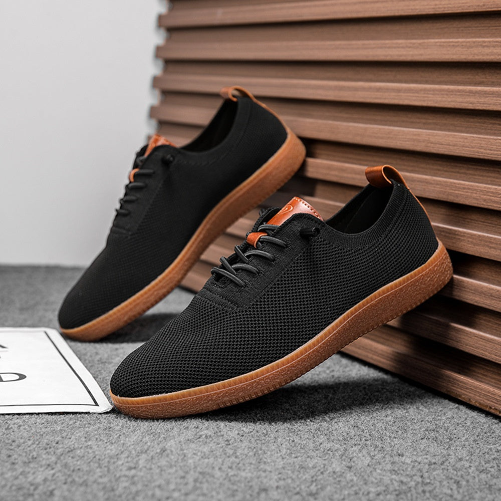 Pair of men's black breathable knit gum-sole sneakers