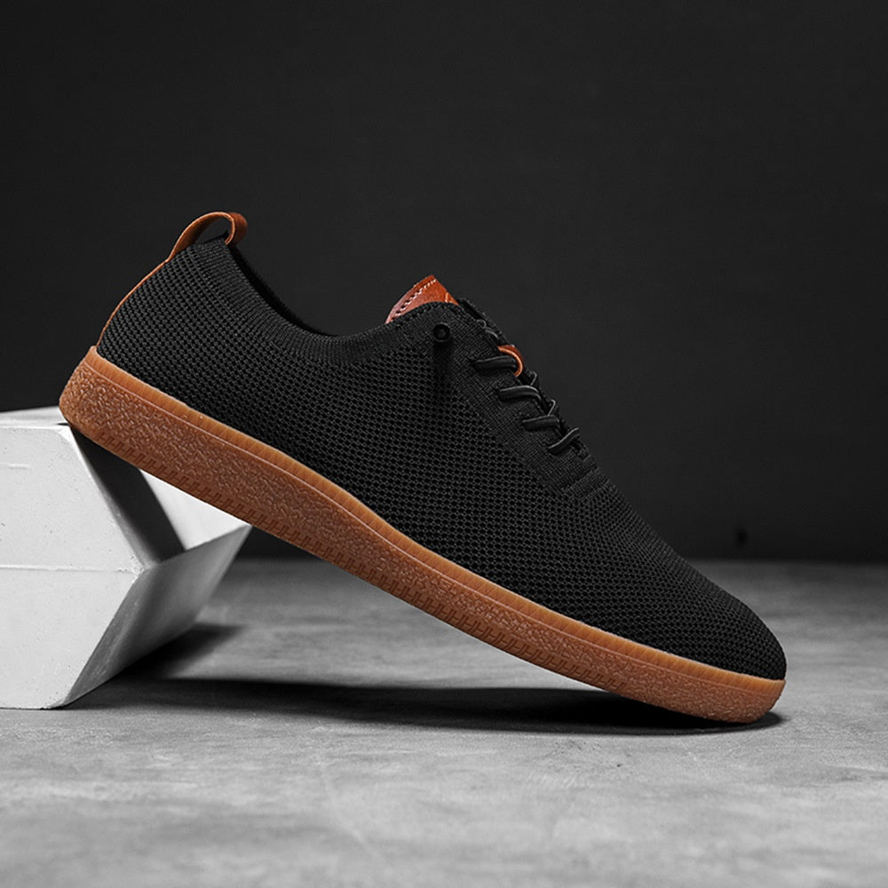 Men's black breathable knit slip-on gum-sole sneaker side view