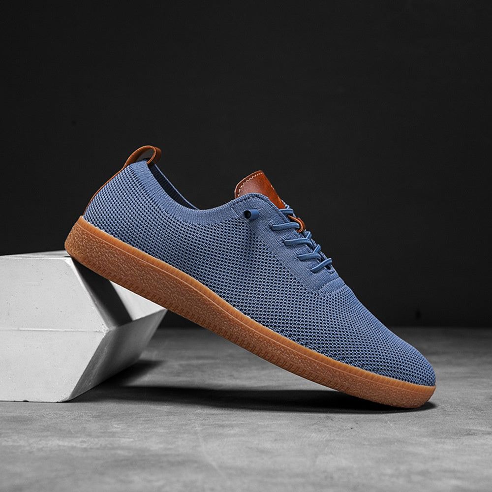 Men's blue breathable knit slip-on gum-sole sneaker side view