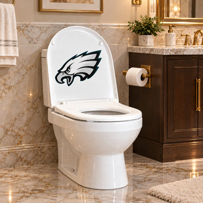 Philadelphia Eagles decorative sticker on the inside of a white toilet lid in a marble bathroom