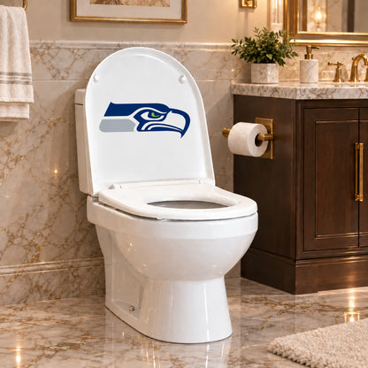 Seattle Seahawks decorative sticker on the inside of a white toilet lid in a marble bathroom