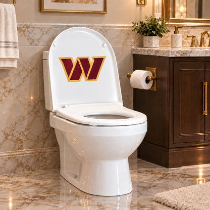 Washington Commanders decorative sticker on the inside of a white toilet lid in a marble bathroom